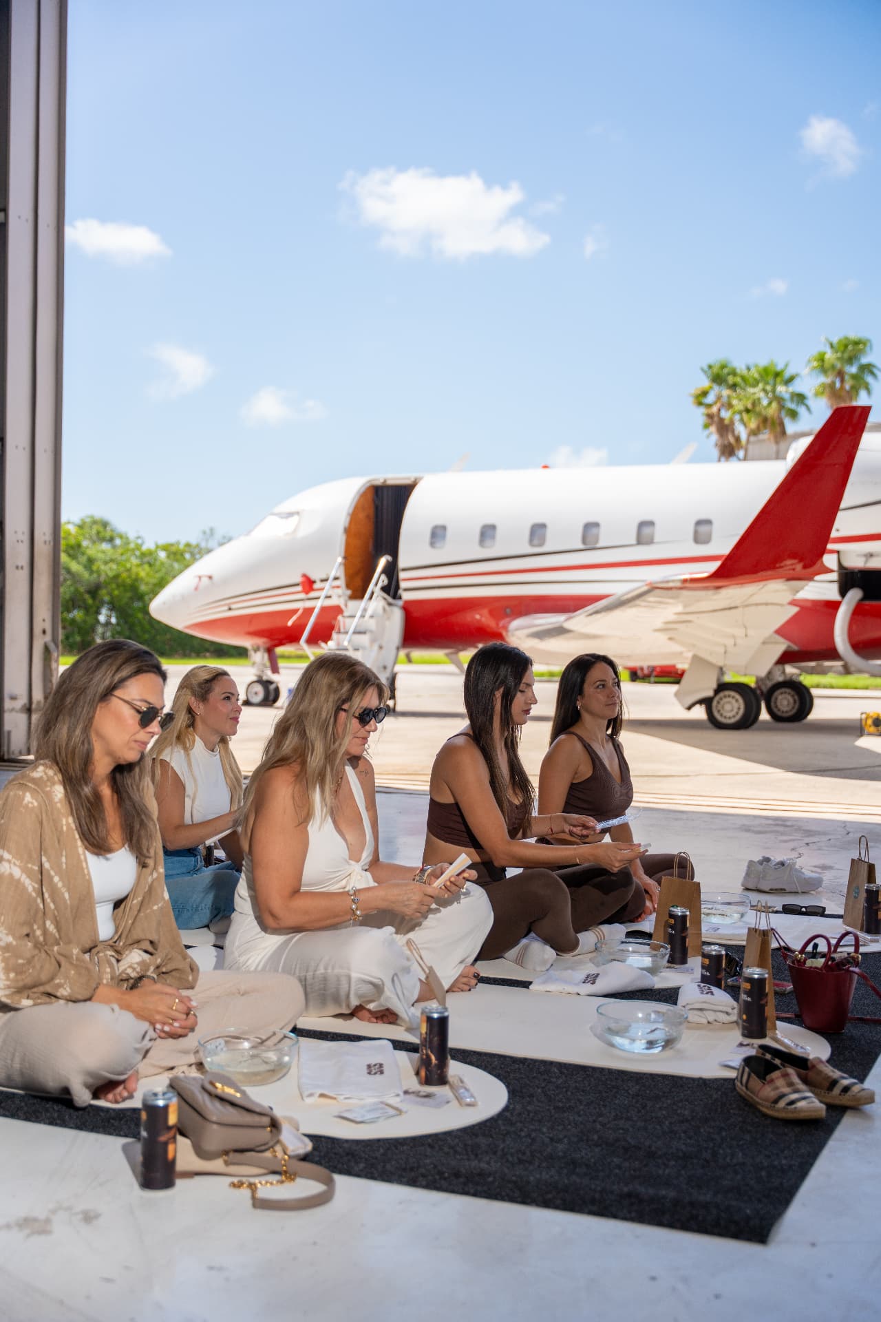 Guests gathered for a Madrigal coffee tasting under an open hangar